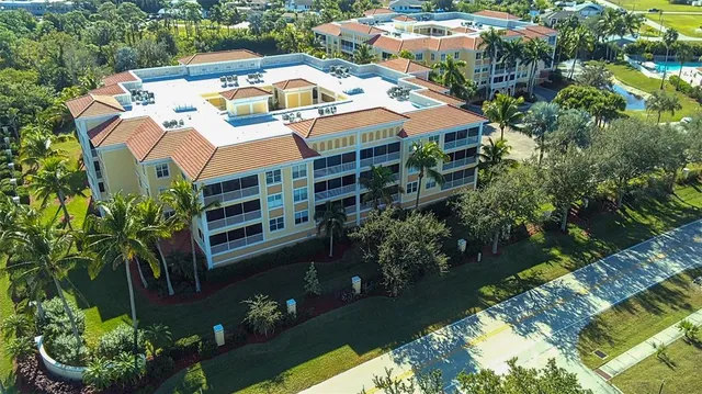 an aerial view of a house with yard swimming pool and lake view