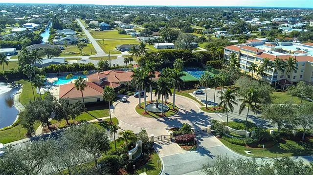 an aerial view of residential houses with outdoor space and swimming pool