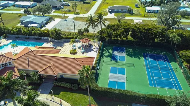 a view of a swimming pool with a patio and a garden