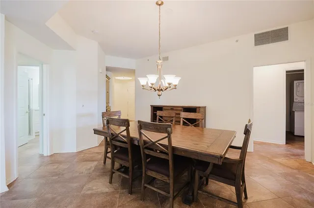 a view of kitchen with granite countertop cabinets and refrigerator