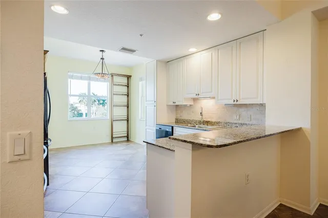 a large kitchen with a refrigerator a sink dishwasher a stove and a refrigerator with wooden floor