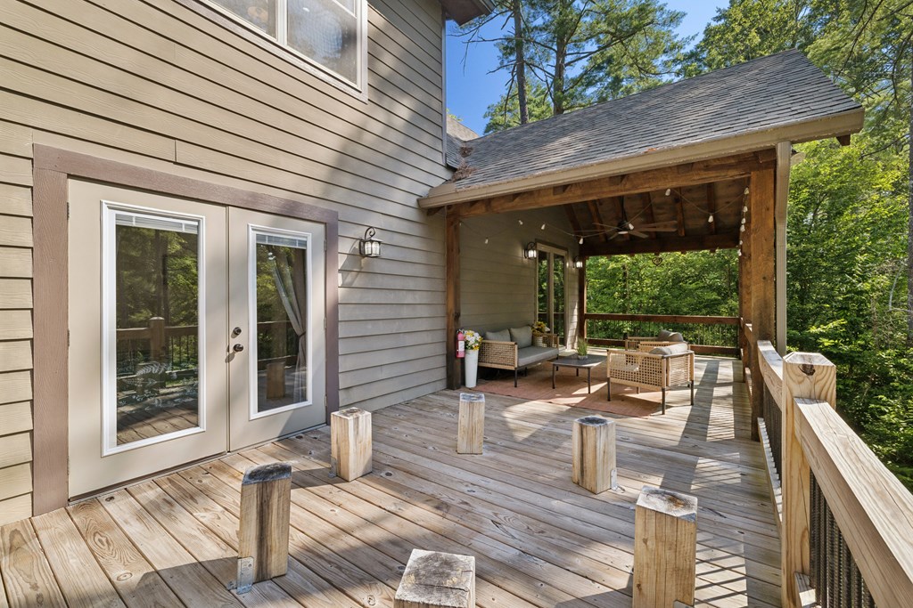 345 Deer Trail Mineral Bluff, GA 30559 - Photo 16 of 31 a view of a patio with table and chairs with wooden floor and fence