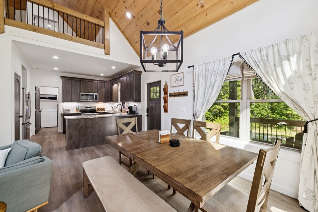 345 Deer Trail Mineral Bluff, GA 30559 - Photo 6 of 31 a view of a dining room with furniture a chandelier and wooden floor
