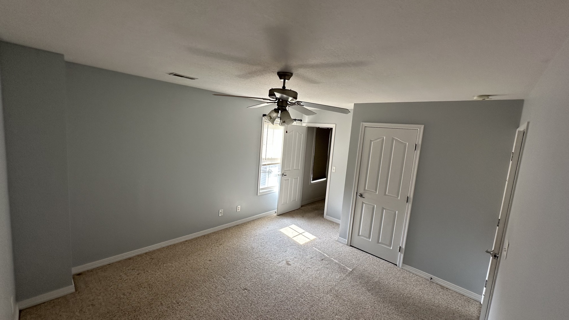 806 Cobblefield Road Champaign, IL 61822 - Photo 9 of 20 a view of a hallway with a chandelier fan and windows