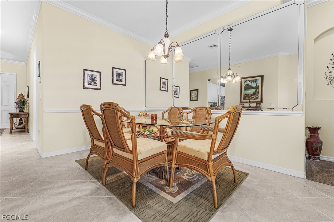 2090 Oxford Ridge Circle Lehigh Acres, FL 33973 - Photo 13 of 27 a dining room with furniture and window