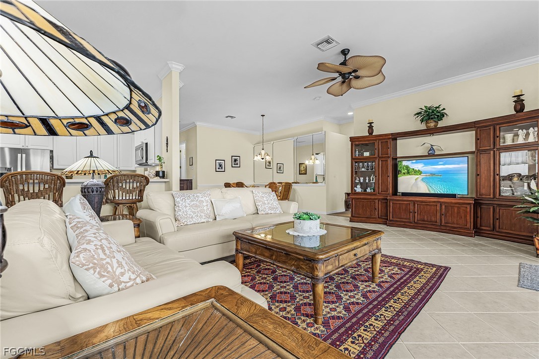 2090 Oxford Ridge Circle Lehigh Acres, FL 33973 - Photo 14 of 27 a living room with furniture a rug and a large window