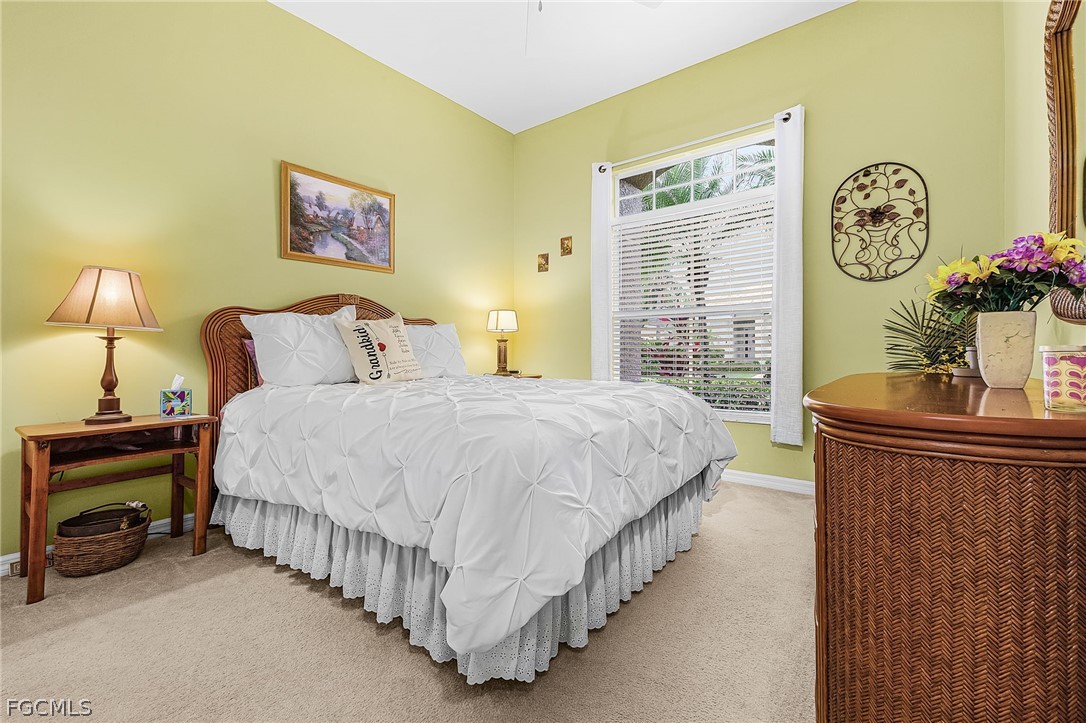 2090 Oxford Ridge Circle Lehigh Acres, FL 33973 - Photo 19 of 27 a bedroom with bed and a window
