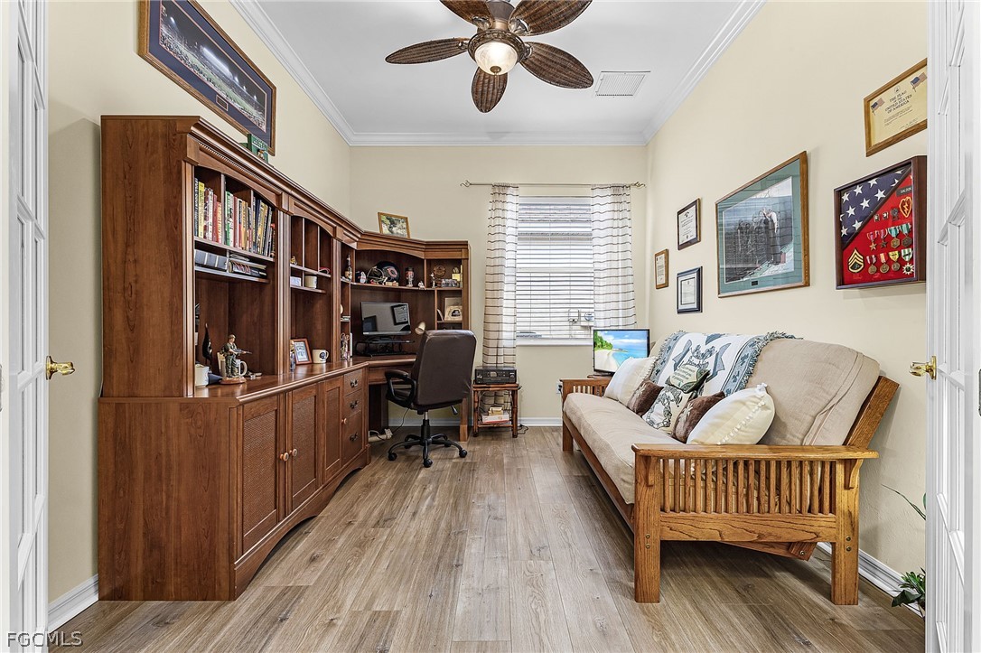 2090 Oxford Ridge Circle Lehigh Acres, FL 33973 - Photo 21 of 27 a bedroom with furniture and a window
