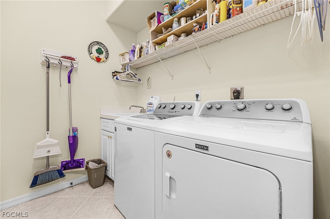 2090 Oxford Ridge Circle Lehigh Acres, FL 33973 - Photo 22 of 27 a utility room with dryer and washer