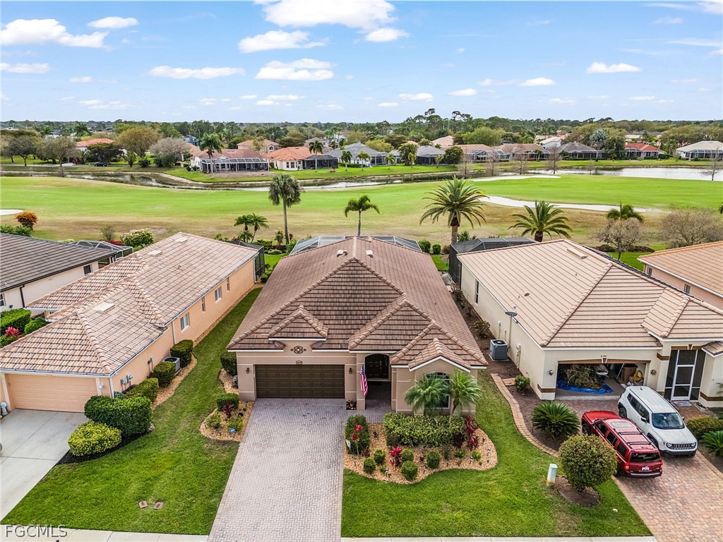 2090 Oxford Ridge Circle Lehigh Acres, FL 33973 - Photo 23 of 27 a aerial view of a house with outdoor space and lake view