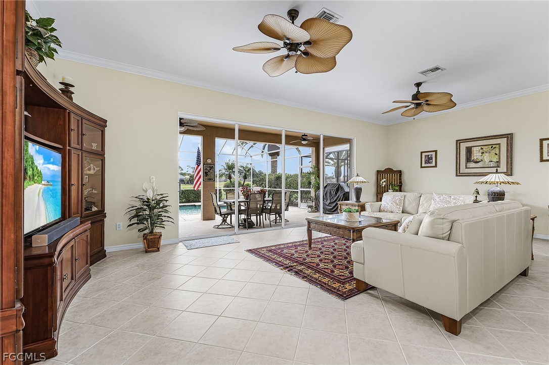 2090 Oxford Ridge Circle Lehigh Acres, FL 33973 - Photo 9 of 27 a living room with furniture and a flat screen tv