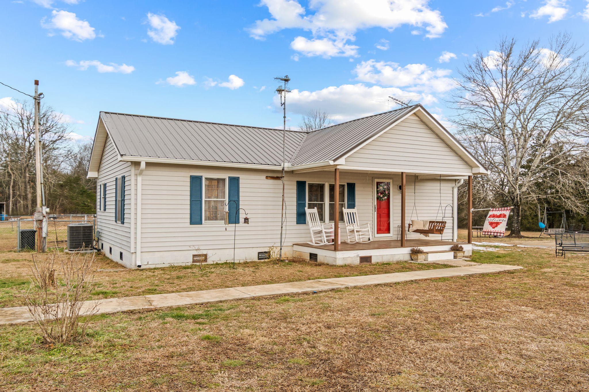 253 Henslee Road Shelbyville, TN 37160 - Photo 2 of 47 a front view of a house with a yard outdoor seating and garage