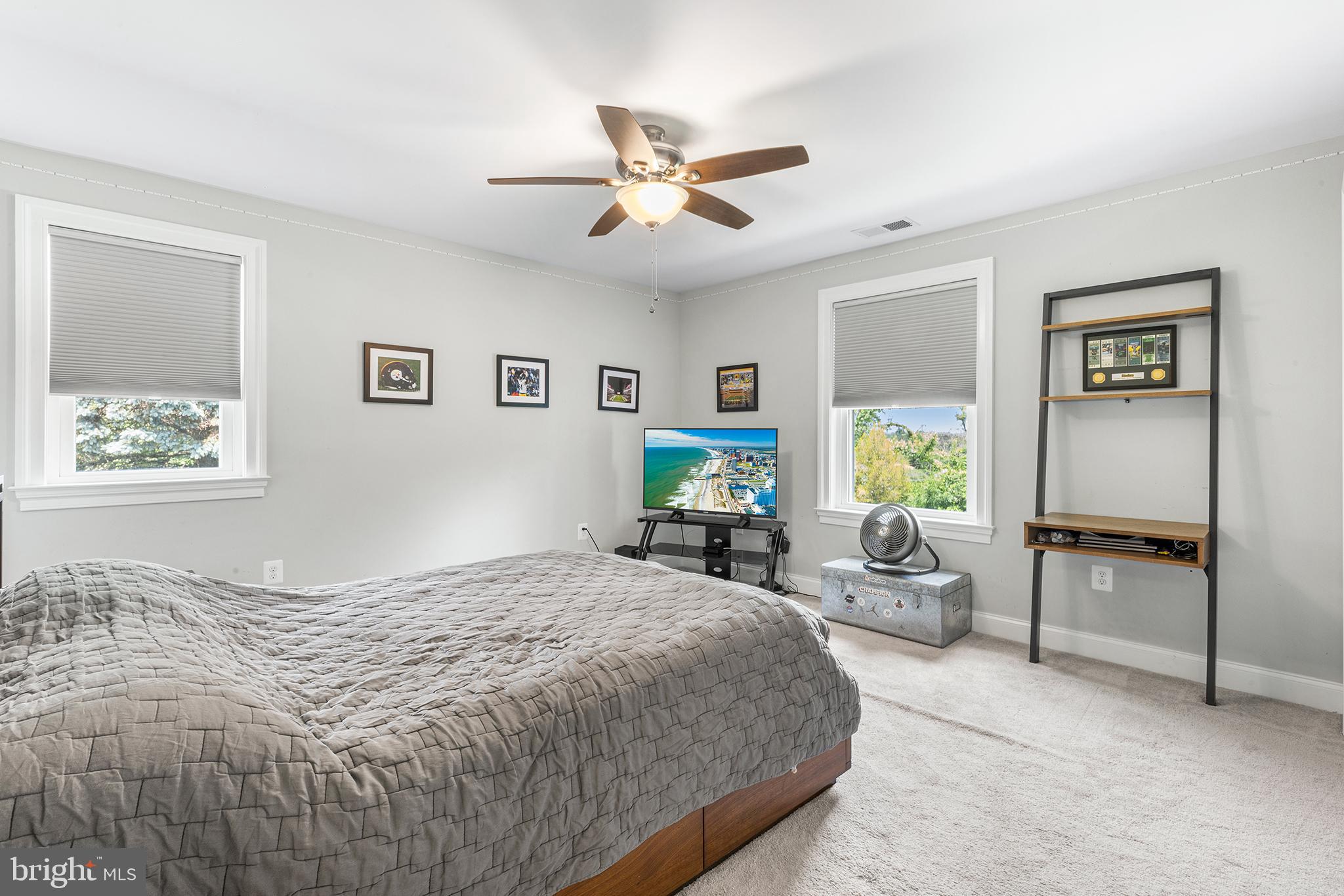 1407 Hagys Ford Road Penn Valley, PA 19072 - Photo 33 of 51 a bedroom with a bed and a chandelier