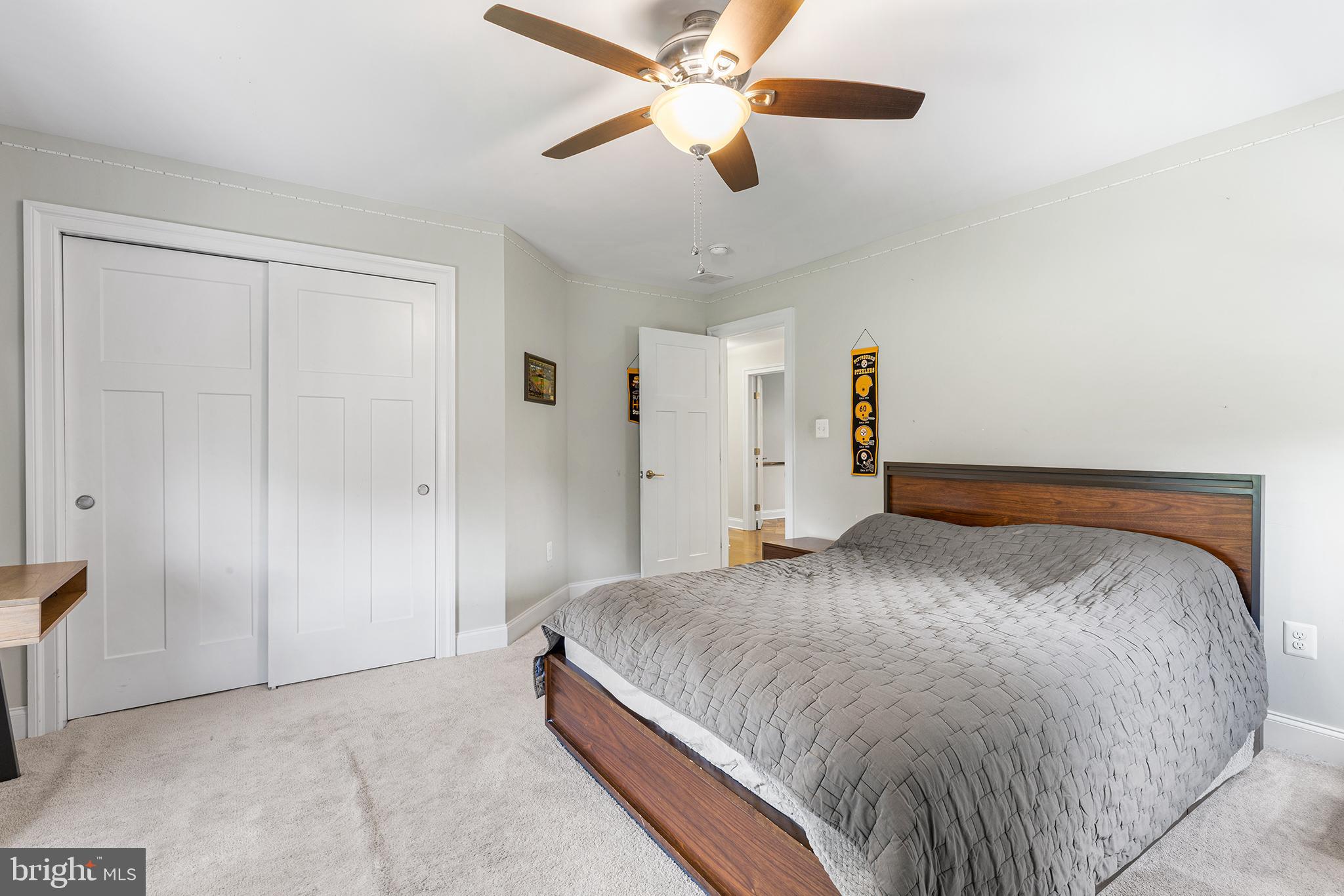 1407 Hagys Ford Road Penn Valley, PA 19072 - Photo 35 of 51 a bedroom with a large bed and a chandelier