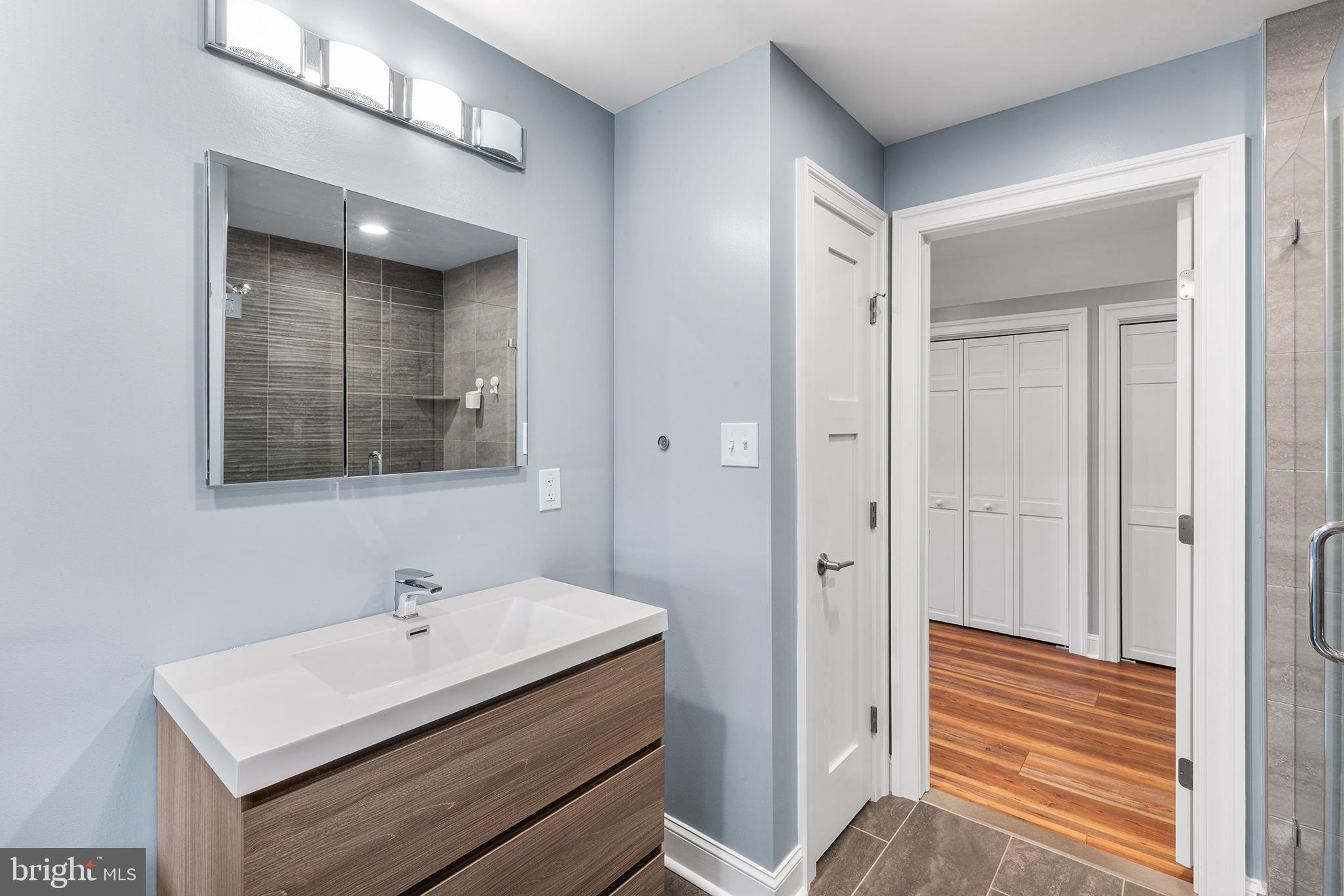 1407 Hagys Ford Road Penn Valley, PA 19072 - Photo 42 of 51 a bathroom with a sink a mirror and a shower