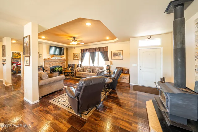 a living room with lots of furniture and a view of kitchen