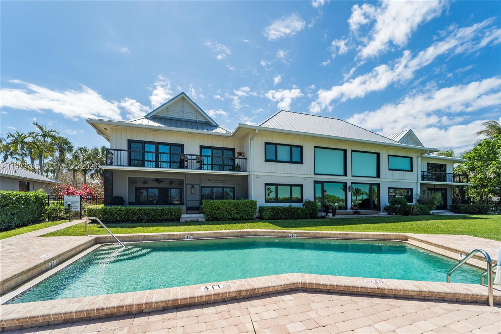 851 Saturn Street, Unit D Jupiter, FL 33477 - Photo 50 of 60 a view of house with swimming pool and yard