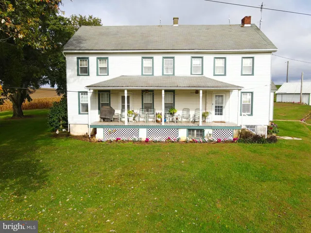 a front view of a house with a yard table and chairs