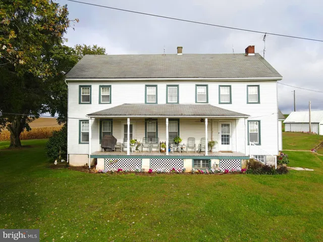 a front view of a house with a yard table and chairs
