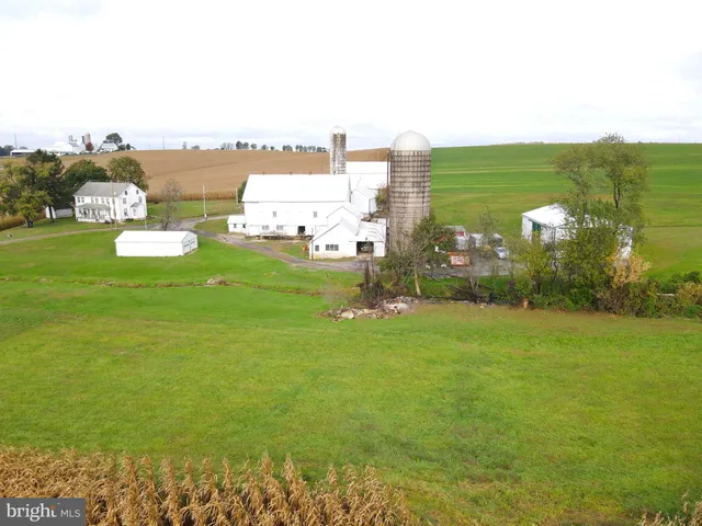 a view of a house with a yard and a lake view