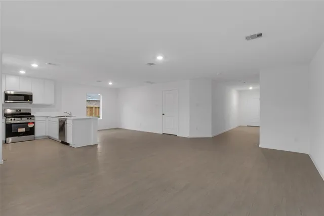 a view of kitchen with microwave and cabinets