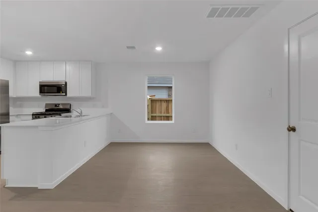 a view of kitchen with center island and stainless steel appliances