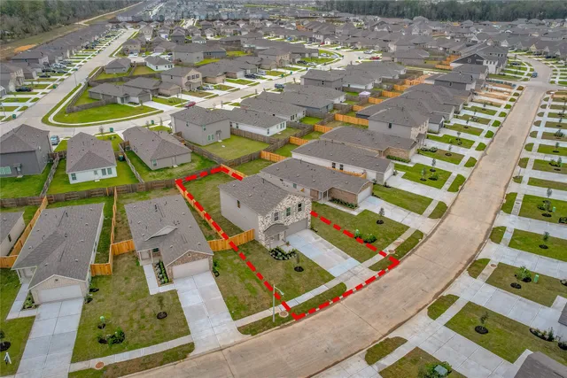 a view of a backyard with a garden and entertaining space