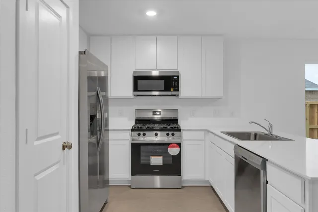 a kitchen with a stove and a sink