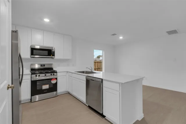 a kitchen with a stove and a microwave