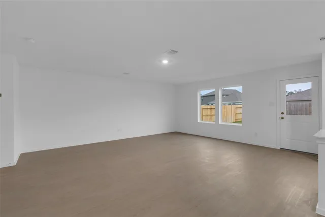 an empty room with a empty space and windows