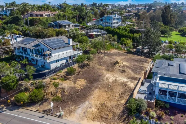 an aerial view of multiple houses with a yard