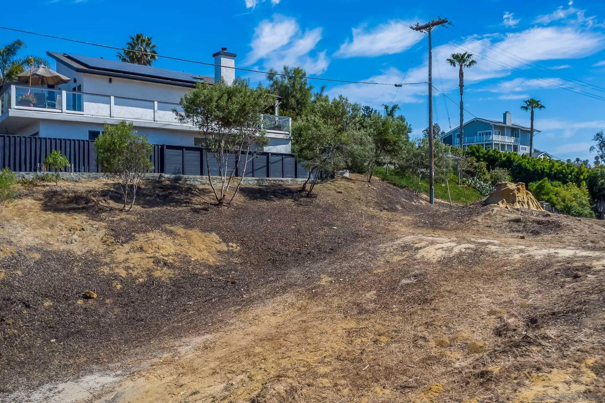97 North Vulcan Avenue, Unit 3 Encinitas, CA 92024 - Photo 9 of 19 a view of a house with a backyard and tree