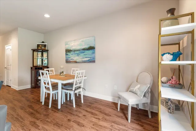 a dining room with furniture and wooden floor