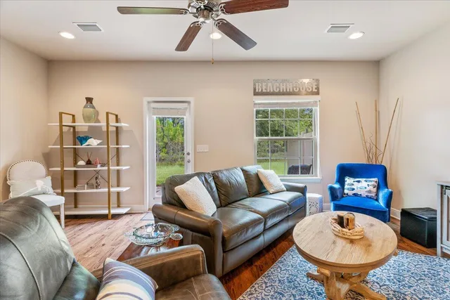 a living room with furniture a rug and a window