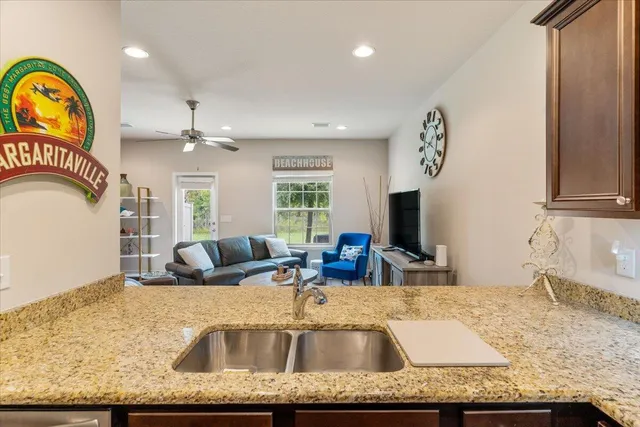 a bathroom with a granite countertop sink a mirror and a window
