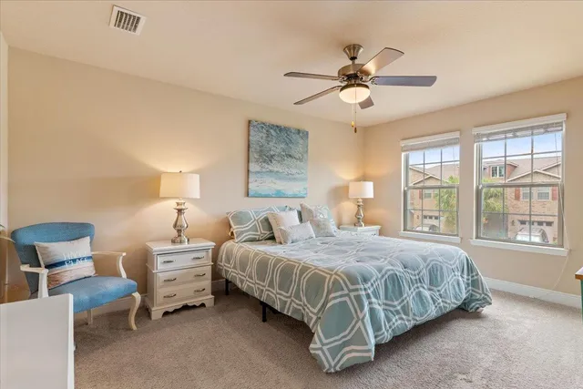 a bedroom with a bed a chandelier and a window