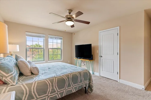 a bedroom with a large bed and a flat screen tv