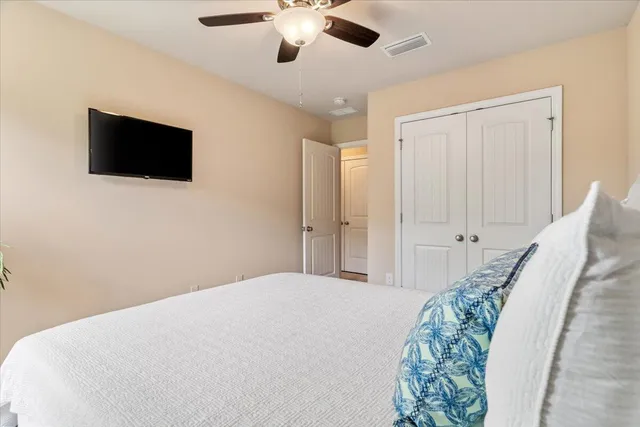 a bedroom with a large bed and a flat screen tv