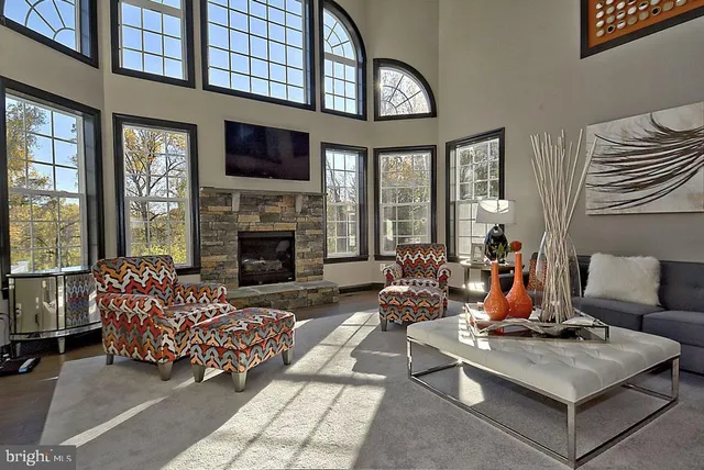 a dining room with furniture a chandelier and wooden floor