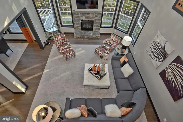 a living room with furniture and floor to ceiling windows