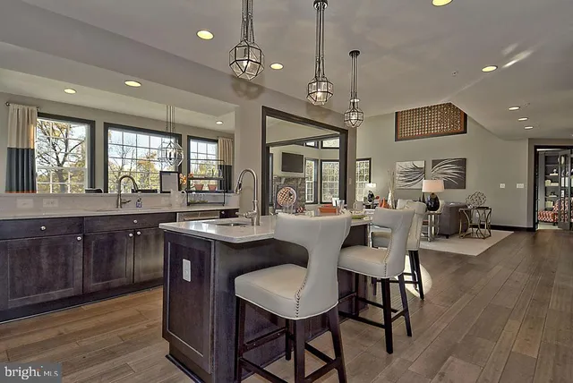 a living room with furniture and floor to ceiling windows