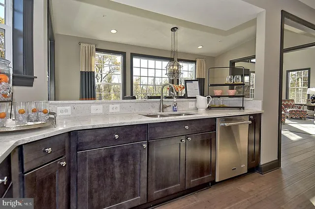 a living room with furniture and floor to ceiling windows
