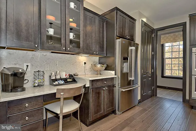 a view of an entryway with wooden floor and windows