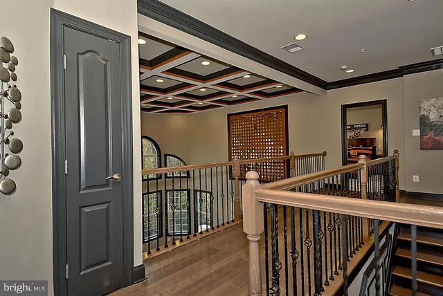a living room with furniture a chandelier and a wooden floor
