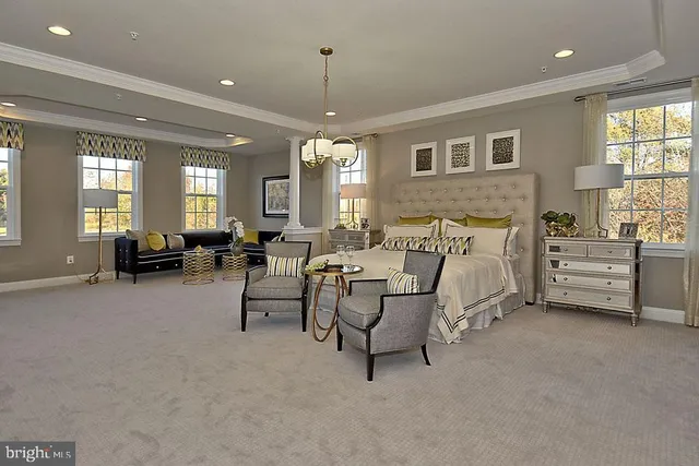 a kitchen with stainless steel appliances kitchen island granite countertop a table chairs sink and cabinets