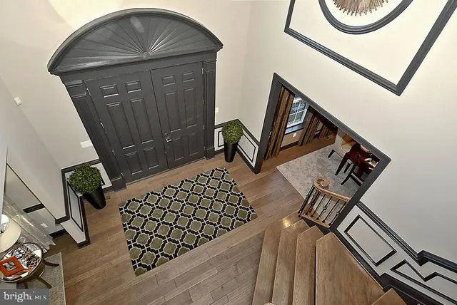 a view of entryway and hall with wooden floor