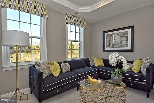 a living room with furniture a flat screen tv and a sink