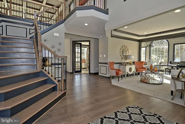 a living room with furniture a rug and a large window