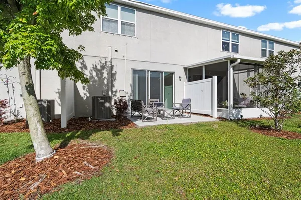 a view of a house with backyard porch and sitting area