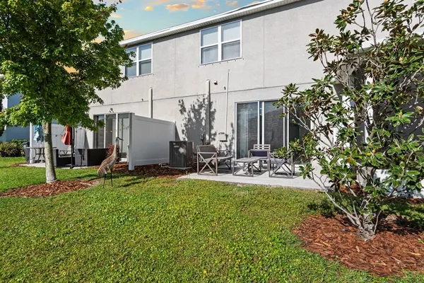 a view of a house with backyard and sitting area